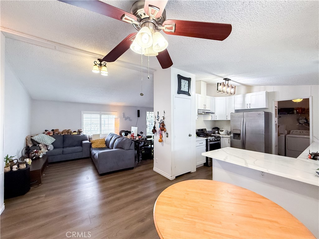 1855 East Riverside, Unit 130 Ontario, CA 91761 - Photo 19 of 62 a living room with furniture and a wooden floor