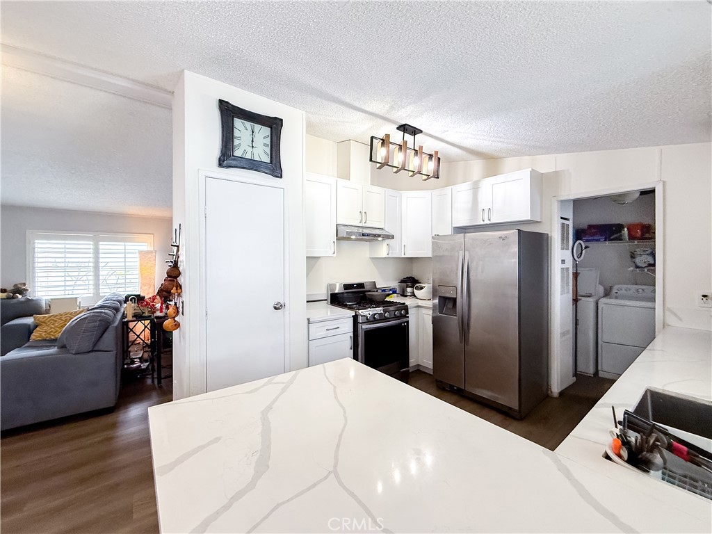 1855 East Riverside, Unit 130 Ontario, CA 91761 - Photo 23 of 62 a kitchen with a refrigerator and a stove top oven