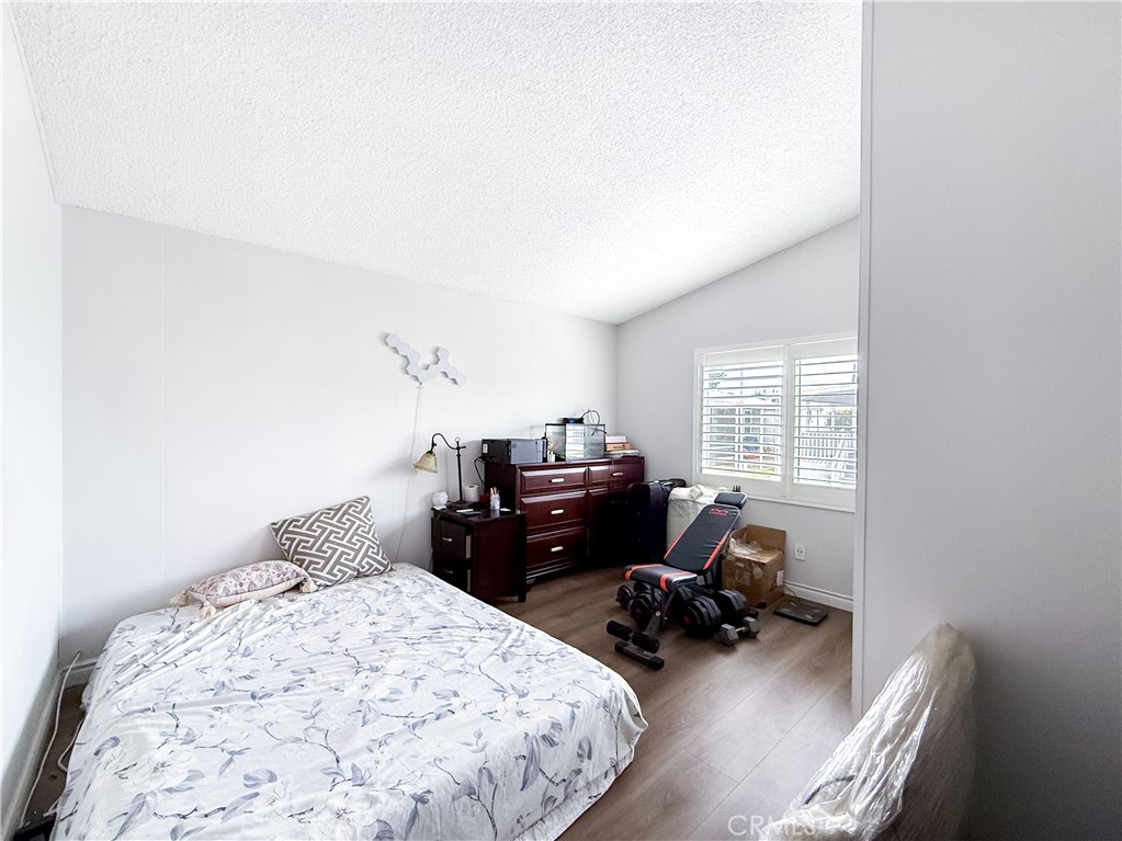 1855 East Riverside, Unit 130 Ontario, CA 91761 - Photo 30 of 62 a bedroom with a bed window and a chair