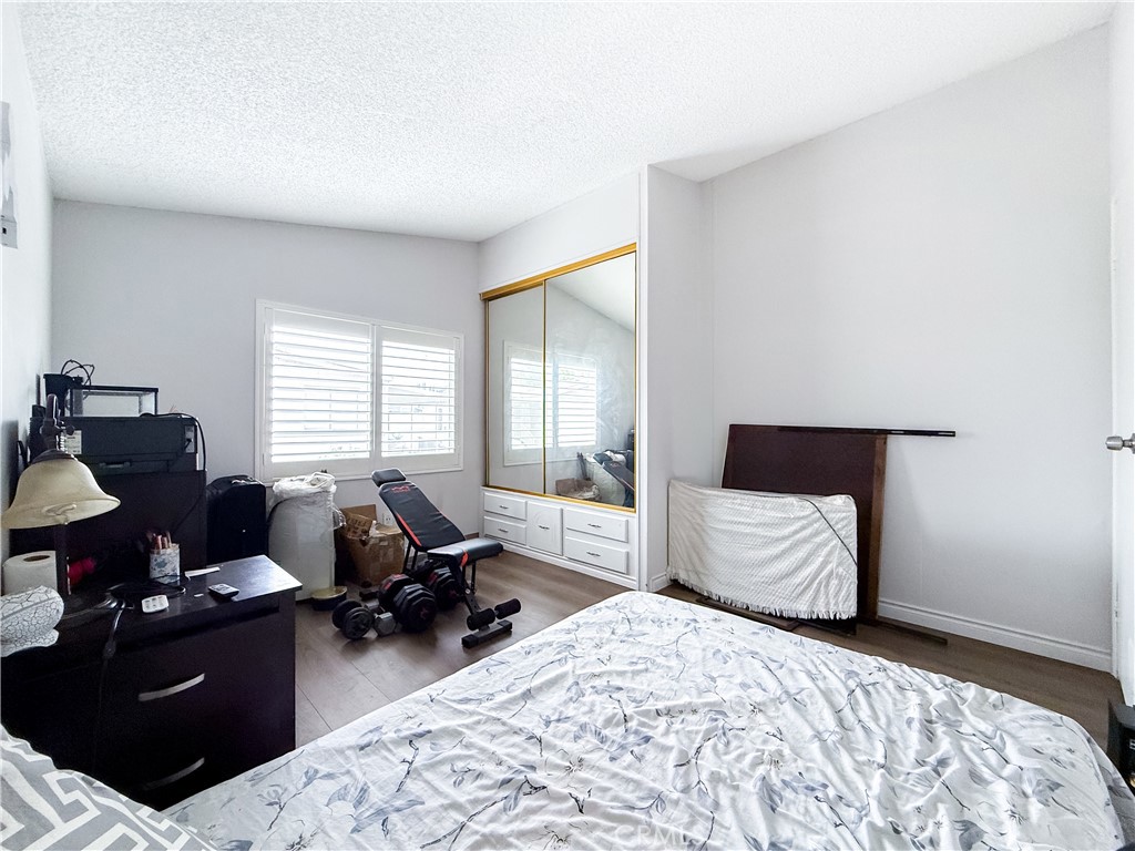 1855 East Riverside, Unit 130 Ontario, CA 91761 - Photo 31 of 62 a bedroom with a bed and wooden floor