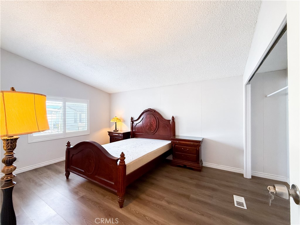 1855 East Riverside, Unit 130 Ontario, CA 91761 - Photo 38 of 62 a bedroom with a bed and window