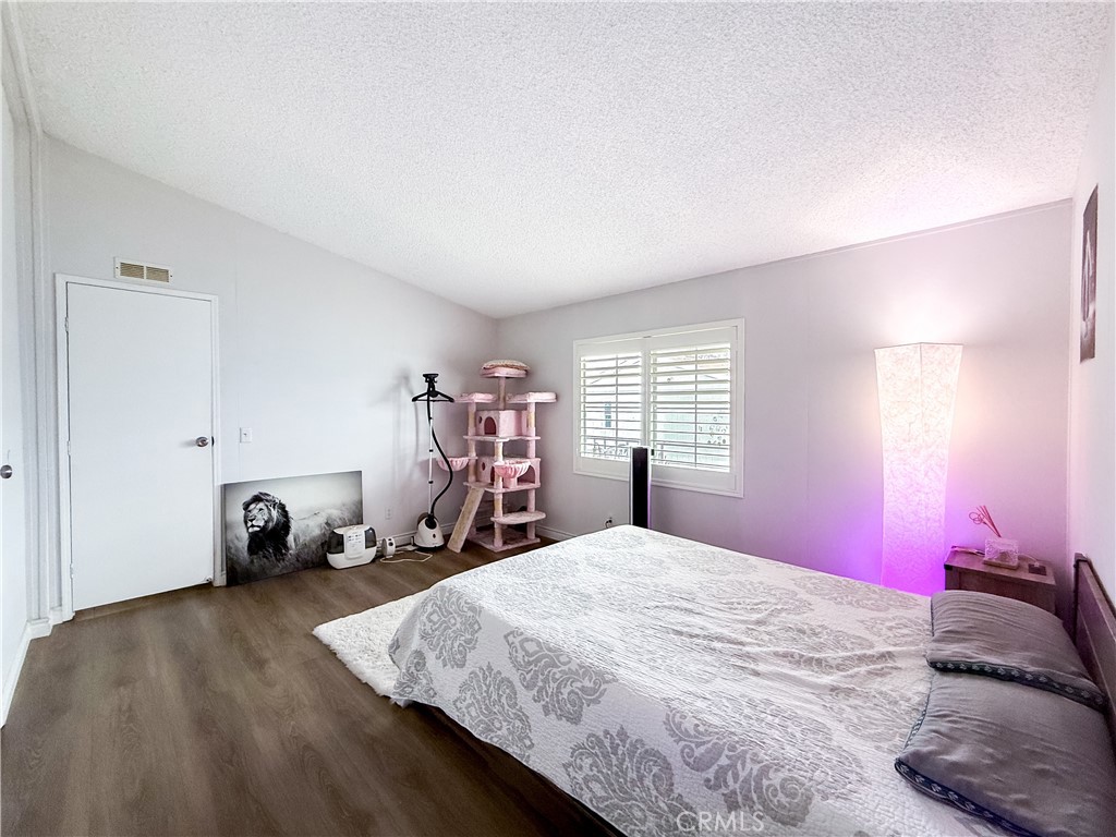 1855 East Riverside, Unit 130 Ontario, CA 91761 - Photo 42 of 62 a bedroom with a bed and a window