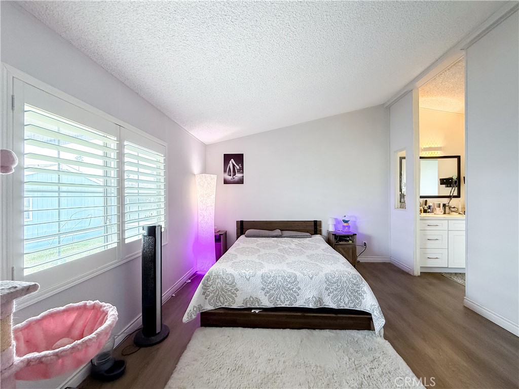 1855 East Riverside, Unit 130 Ontario, CA 91761 - Photo 43 of 62 a bedroom with a bed and wooden floor