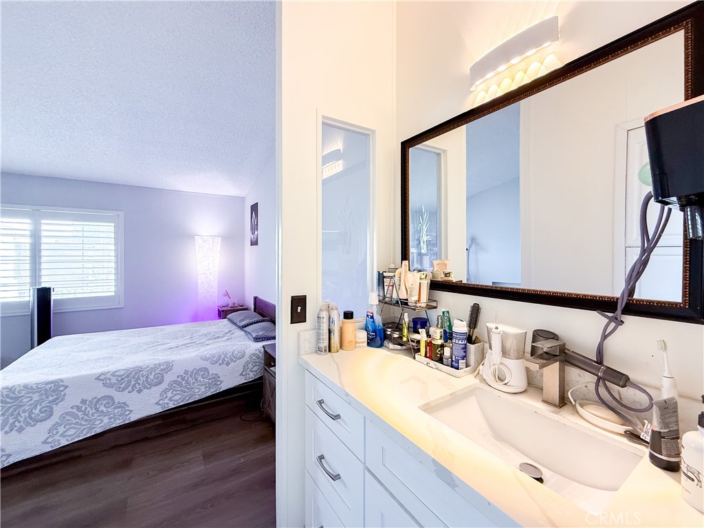1855 East Riverside, Unit 130 Ontario, CA 91761 - Photo 44 of 62 a bedroom with a sink and a mirror