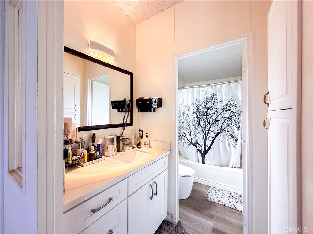 1855 East Riverside, Unit 130 Ontario, CA 91761 - Photo 48 of 62 a bathroom with a double vanity sink mirror and toilet