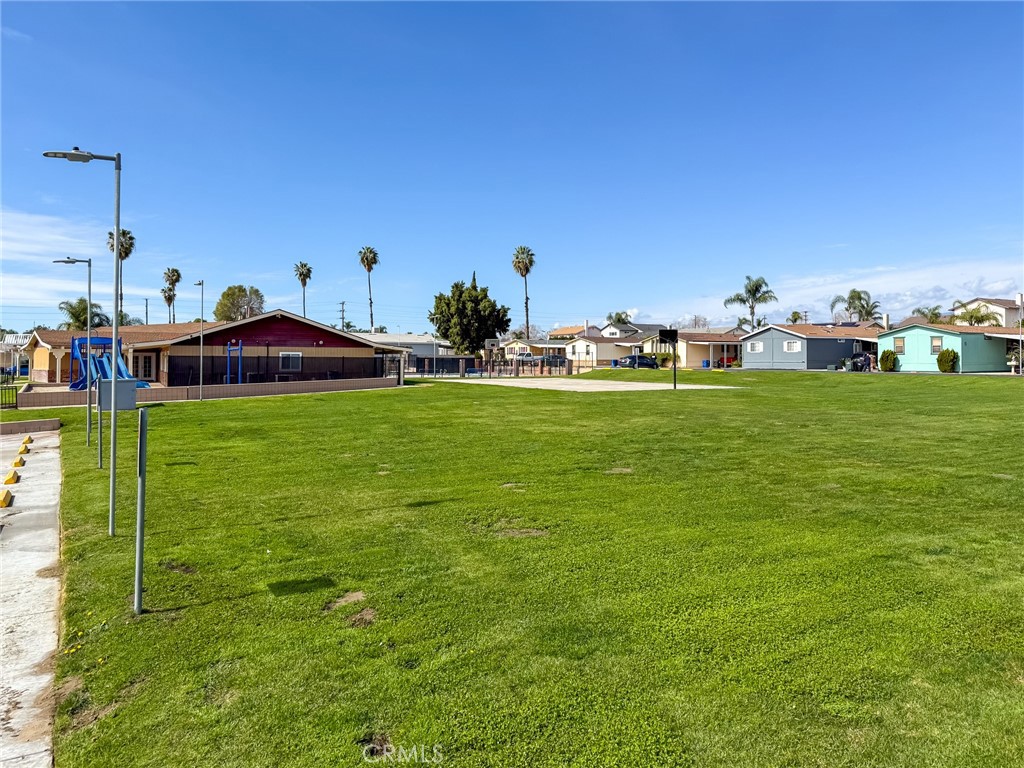 1855 East Riverside, Unit 130 Ontario, CA 91761 - Photo 58 of 62 a view of a house with a yard