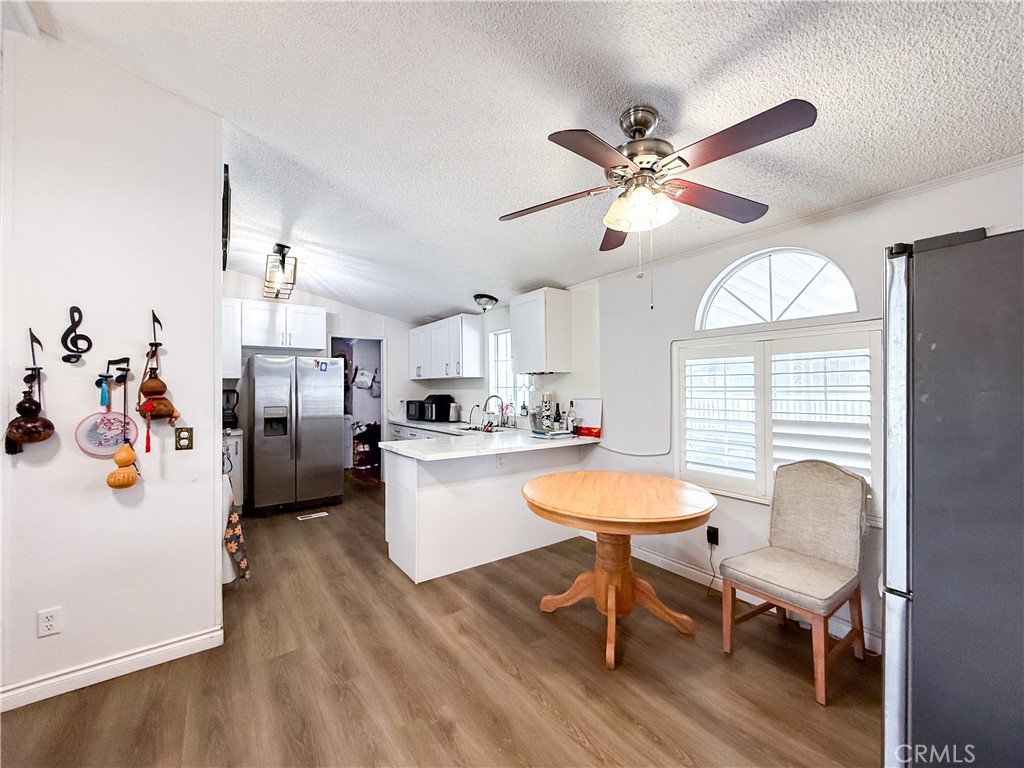 1855 East Riverside, Unit 130 Ontario, CA 91761 - Photo 9 of 62 a dining room with furniture a window and wooden floor