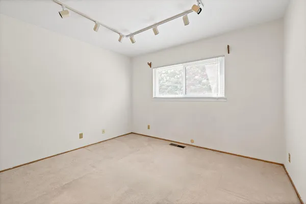 a view of a room with window and a ceiling fan