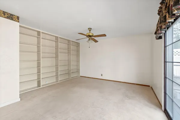 a view of a room with cabinet and a ceiling fan
