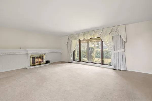 an empty room with windows and city view