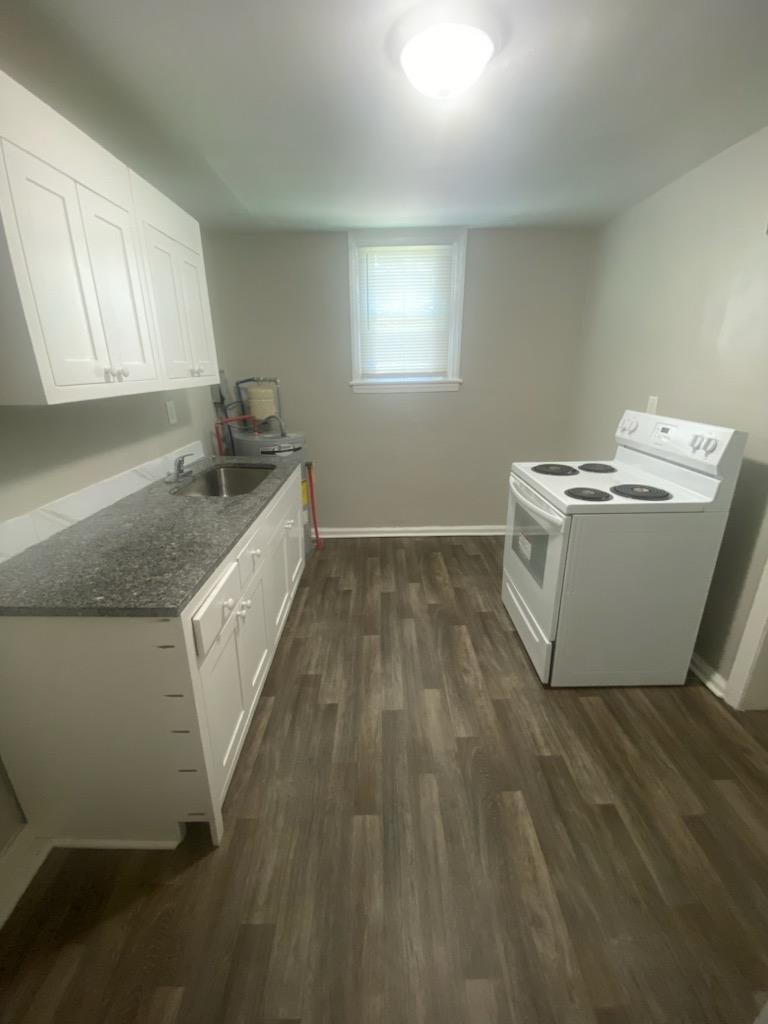 477 Mellon Street, Unit E Columbus, GA 31903 - Photo 2 of 5 a utility room with wooden floor washer and dryer