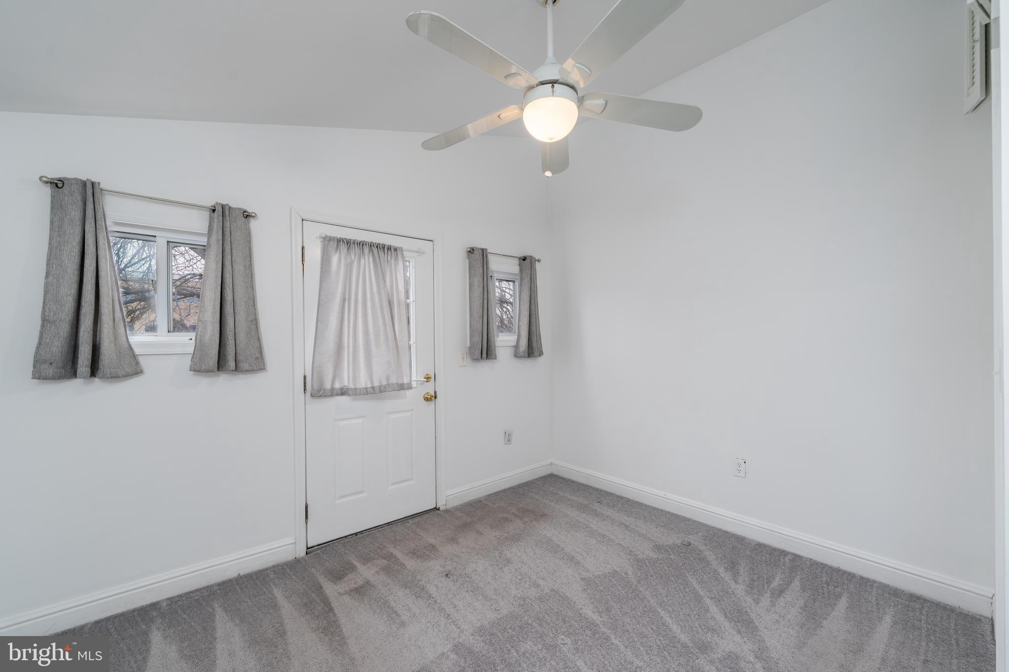 1153 Riverside Avenue Baltimore, MD 21230 - Photo 15 of 35 an empty room with windows and fan