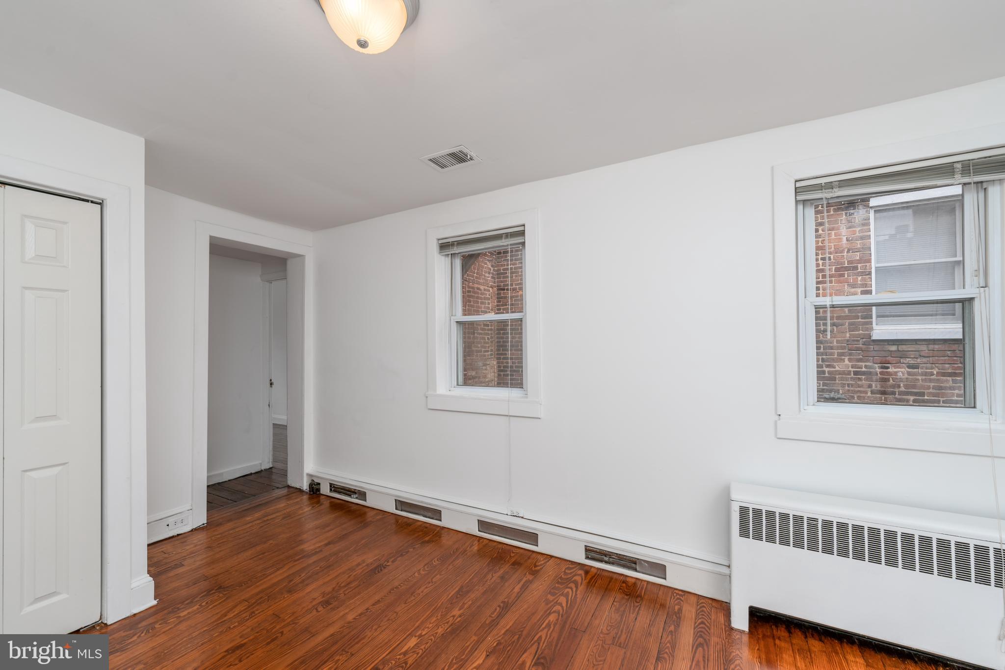 1153 Riverside Avenue Baltimore, MD 21230 - Photo 23 of 35 a view of an empty room with wooden floor and a window