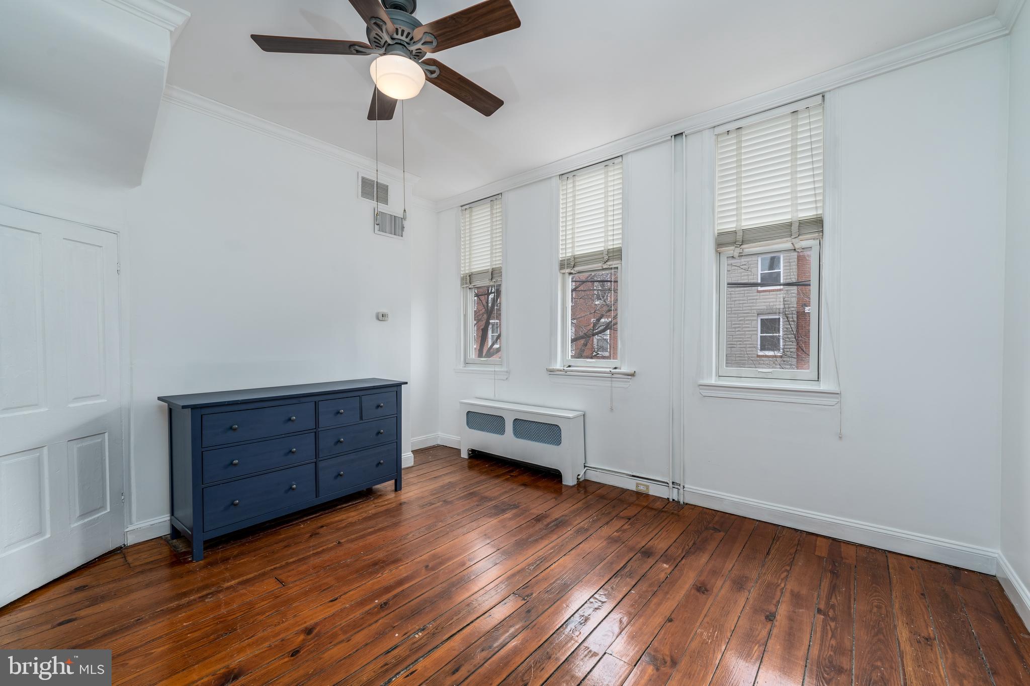 1153 Riverside Avenue Baltimore, MD 21230 - Photo 29 of 35 a room with wooden floors and ceiling fan