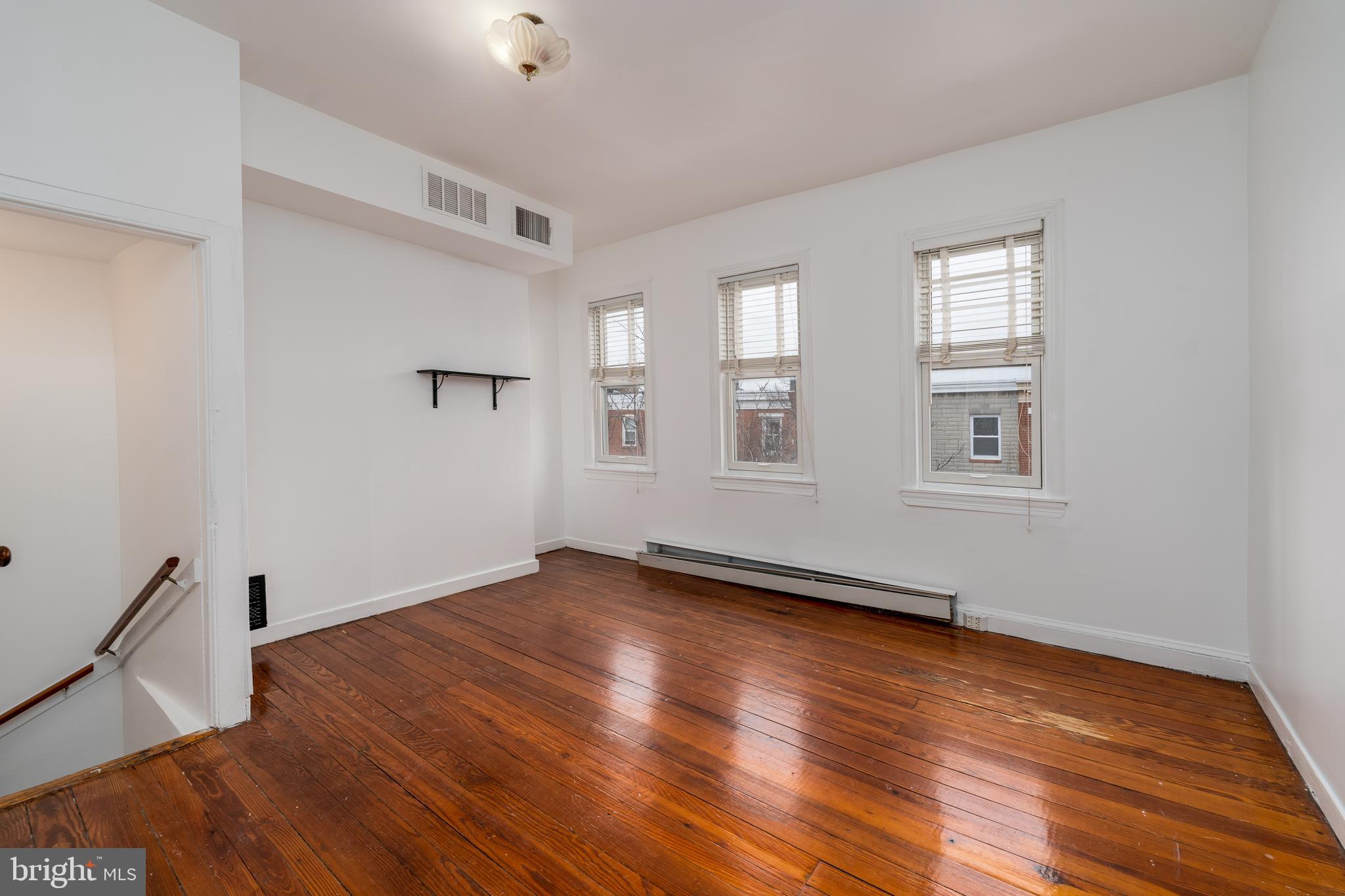 1153 Riverside Avenue Baltimore, MD 21230 - Photo 31 of 35 a view of an empty room with wooden floor and a window