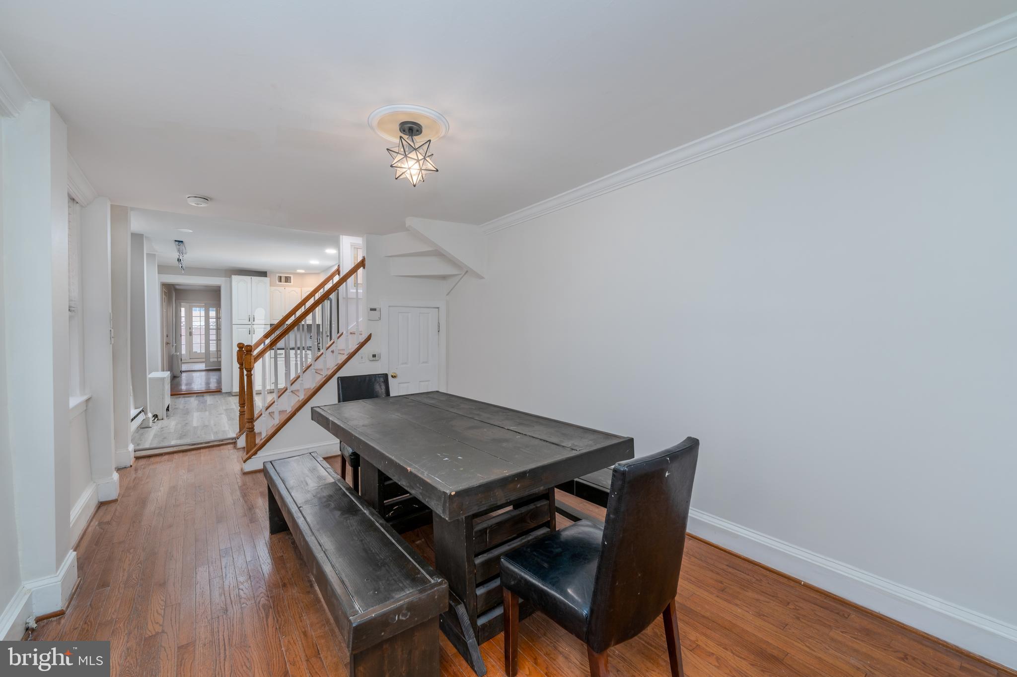 1153 Riverside Avenue Baltimore, MD 21230 - Photo 5 of 35 a dining room with wooden floor and stairs