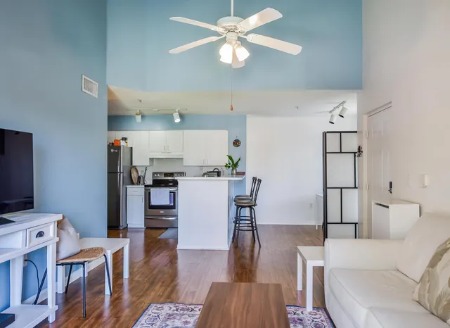 a living room with furniture and wooden floor