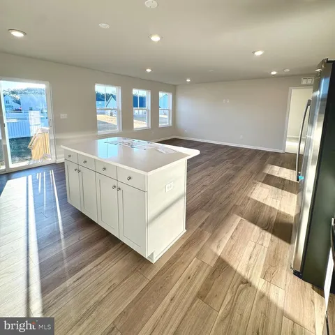 a kitchen with a sink and wooden floor