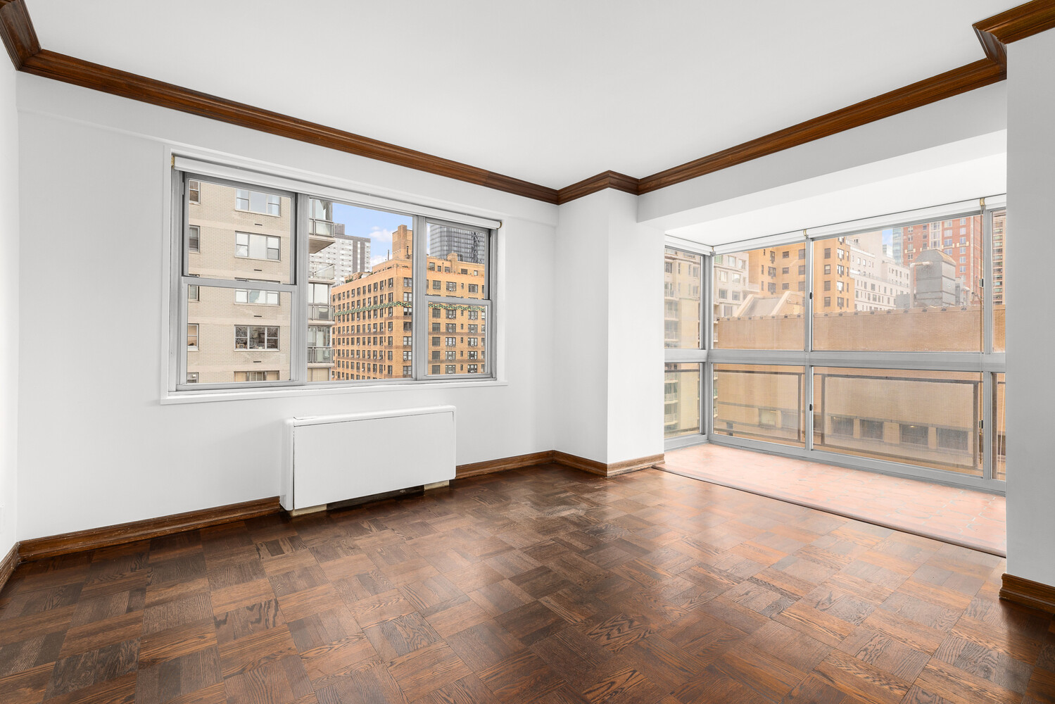 150 East 69th Street, Unit 11L Manhattan, NY 10021 - Photo 11 of 13 an empty room with wooden floor and windows