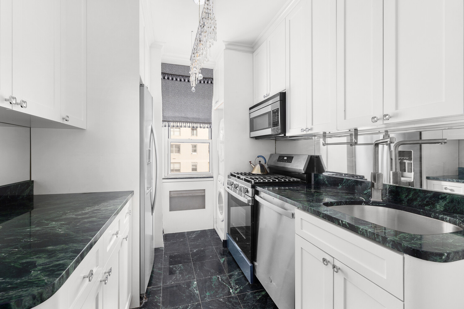 150 East 69th Street, Unit 11L Manhattan, NY 10021 - Photo 6 of 13 a kitchen with stainless steel appliances granite countertop a sink stove and refrigerator