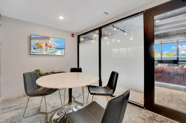a view of a dining room with furniture and a potted plant