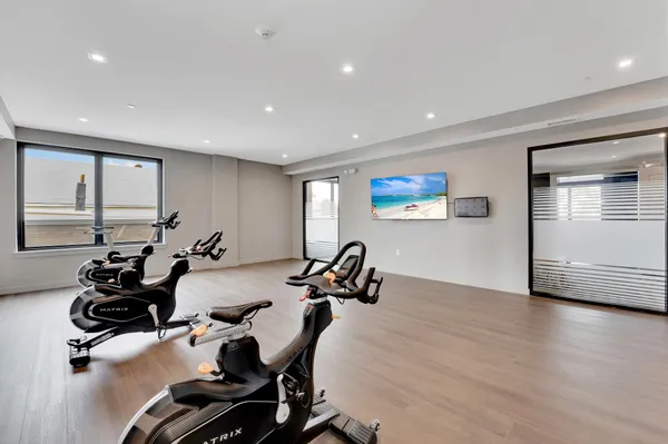 a room with gym equipment and a large window