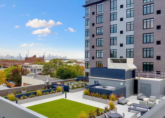 a swimming pool with outdoor seating and a yard
