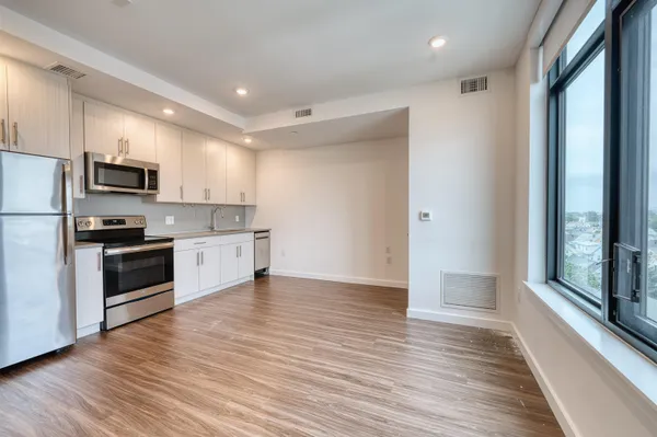 a kitchen with stainless steel appliances a refrigerator and a stove top oven