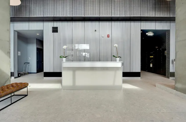 an open kitchen with granite countertop a sink and a refrigerator