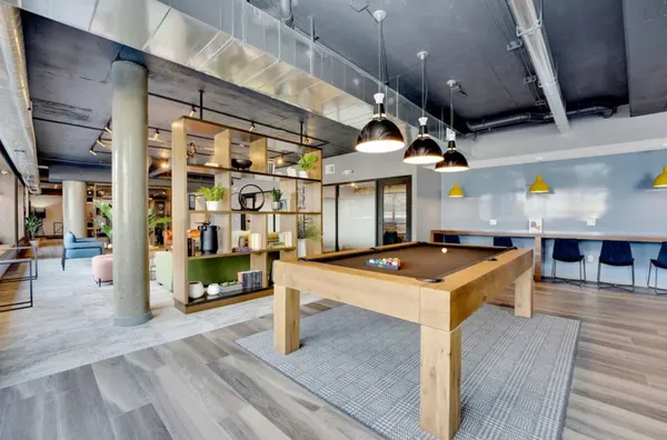 a kitchen with stainless steel appliances granite countertop a sink a stove and a wooden floors