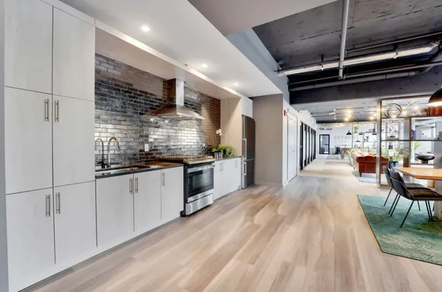 a kitchen with stainless steel appliances granite countertop a stove a sink and a refrigerator