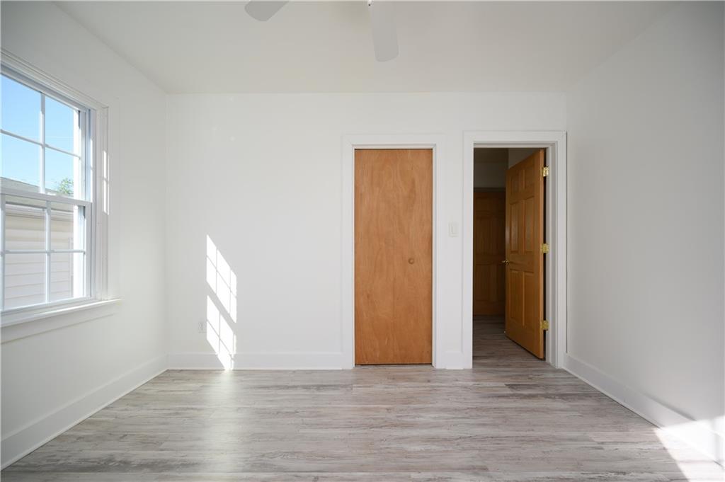 532 Oregon Avenue Rochester, PA 15074 - Photo 11 of 25 a view of an empty room with wooden floor and a window