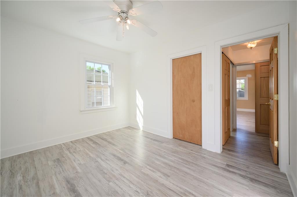 532 Oregon Avenue Rochester, PA 15074 - Photo 14 of 25 an empty room with wooden floor closet and windows