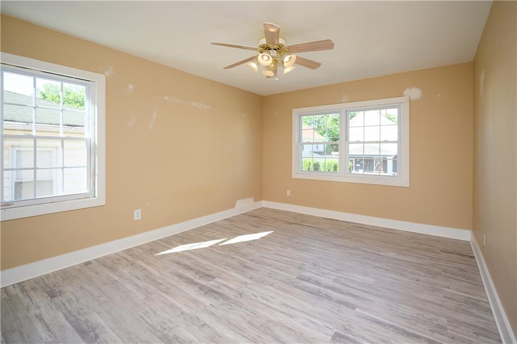 532 Oregon Avenue Rochester, PA 15074 - Photo 9 of 25 a view of an empty room with wooden floor and a window