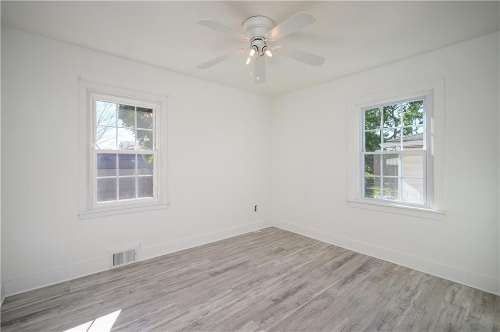 532 Oregon Avenue Rochester, PA 15074 - Photo 10 of 25 an empty room with wooden floor ceiling fan and windows