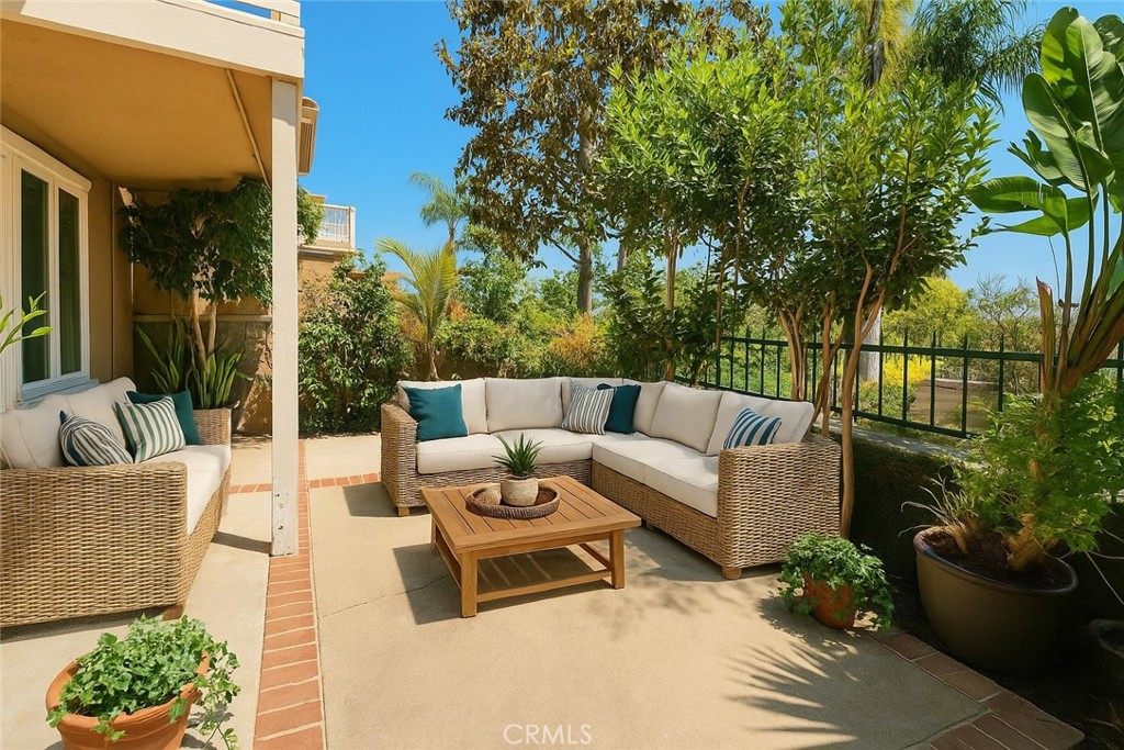 87 Matisse Circle, Unit CI42 Aliso Viejo, CA 92656 - Photo 13 of 19 a view of a patio with couches and potted plants