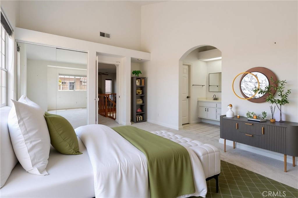 87 Matisse Circle, Unit CI42 Aliso Viejo, CA 92656 - Photo 6 of 19 a bedroom with a bed and a chandelier