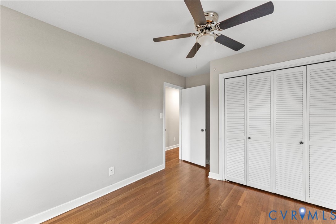 159 2nd Street Appomattox, VA 24522 - Photo 22 of 30 an empty room with wooden floor ceiling fan and window