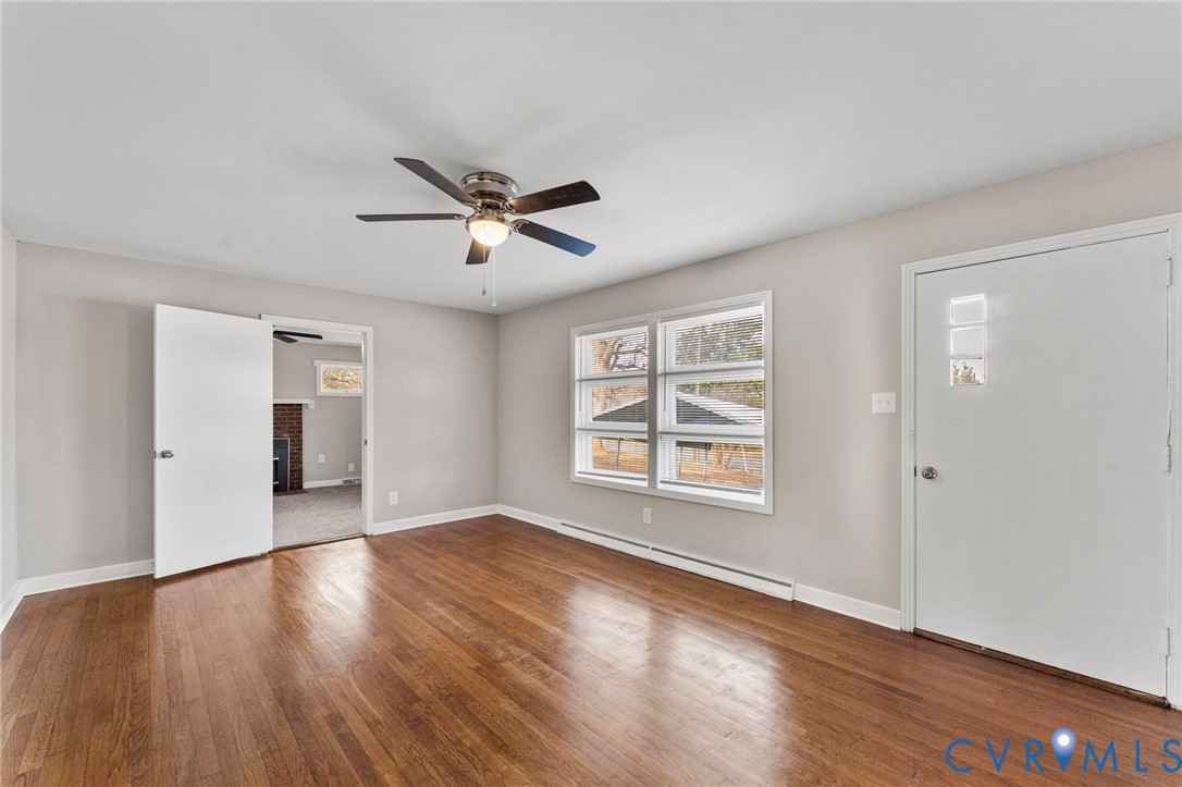 159 2nd Street Appomattox, VA 24522 - Photo 4 of 30 an empty room with wooden floor and windows