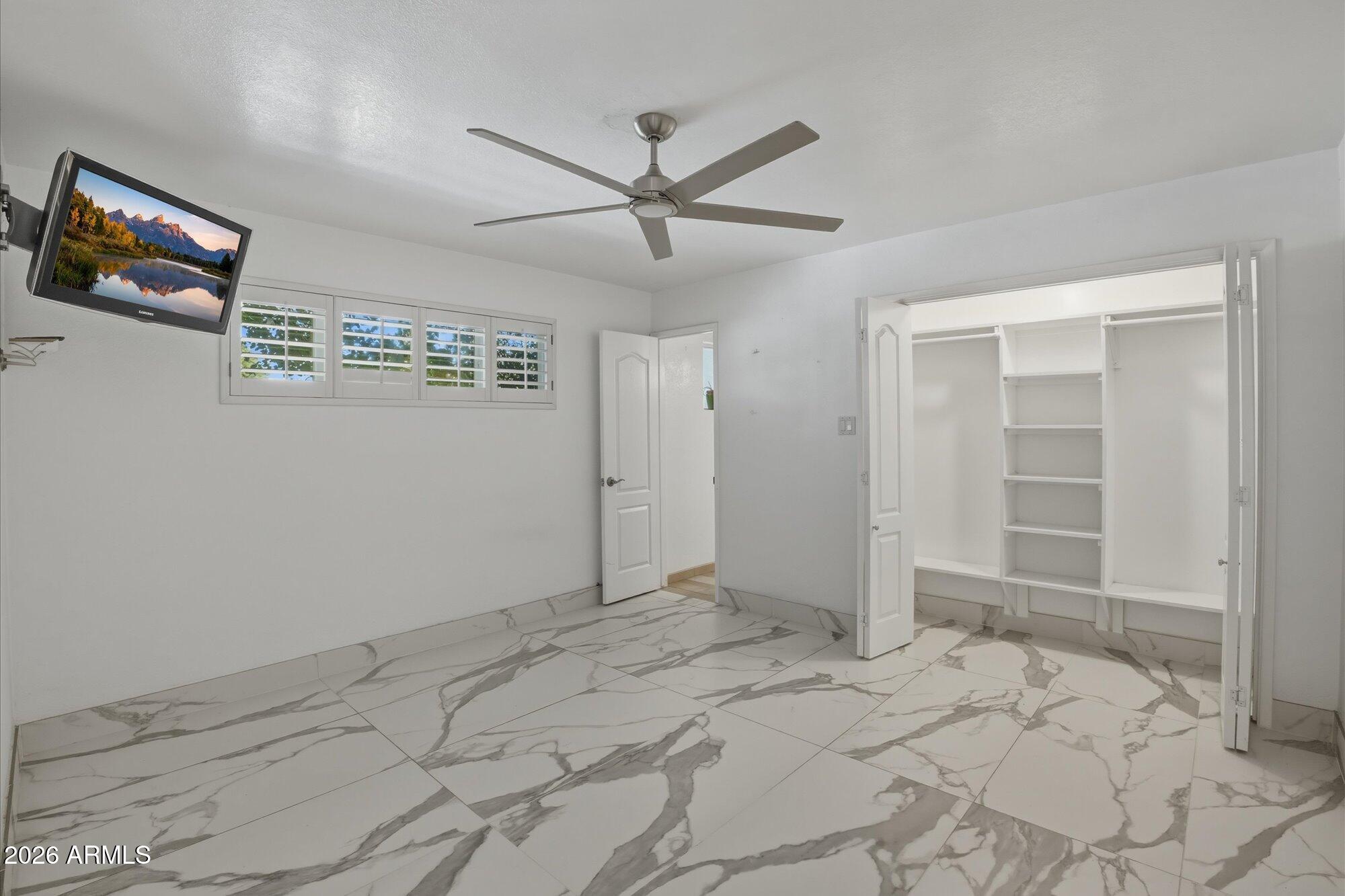 1532 West Loma Lane Phoenix, AZ 85021 - Photo 11 of 19 a view of a livingroom with wooden floor and a ceiling fan