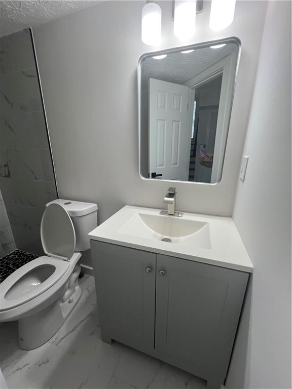 3715 Cress Way Drive Decatur, GA 30034 - Photo 24 of 37 a bathroom with a toilet a sink and mirror