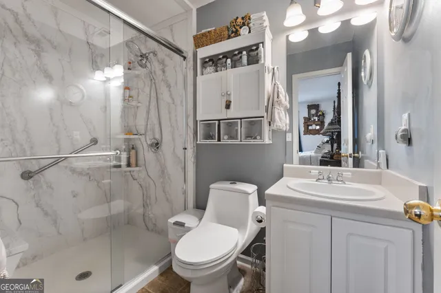 a bathroom with a sink toilet and shower