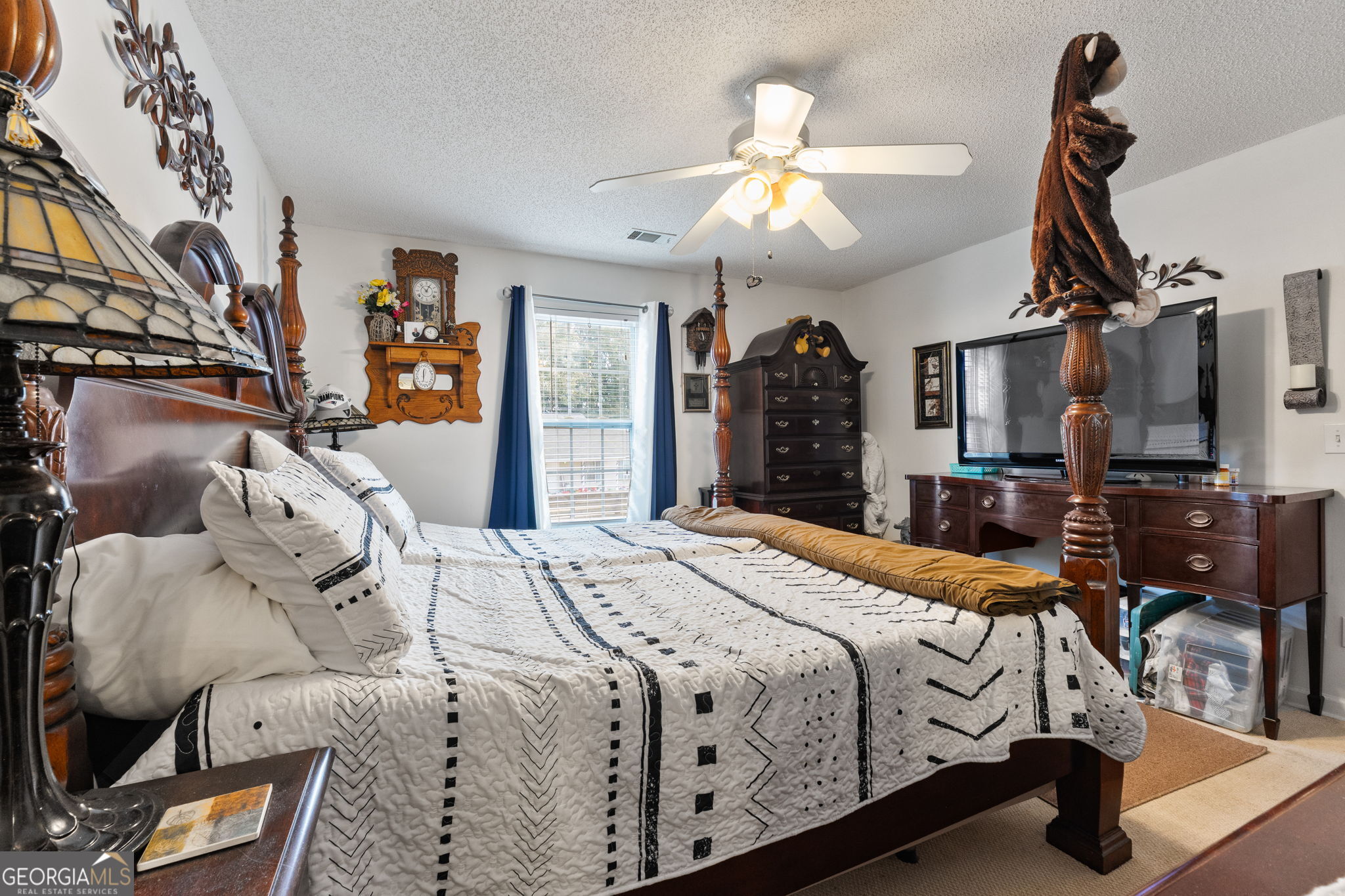 291 Regal Road Jackson, GA 30233 - Photo 15 of 35 a bedroom with bed and a chandelier