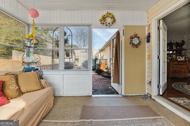 a living room with furniture and a floor to kitchen