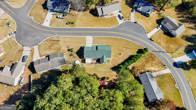 an aerial view of a house with a swimming pool