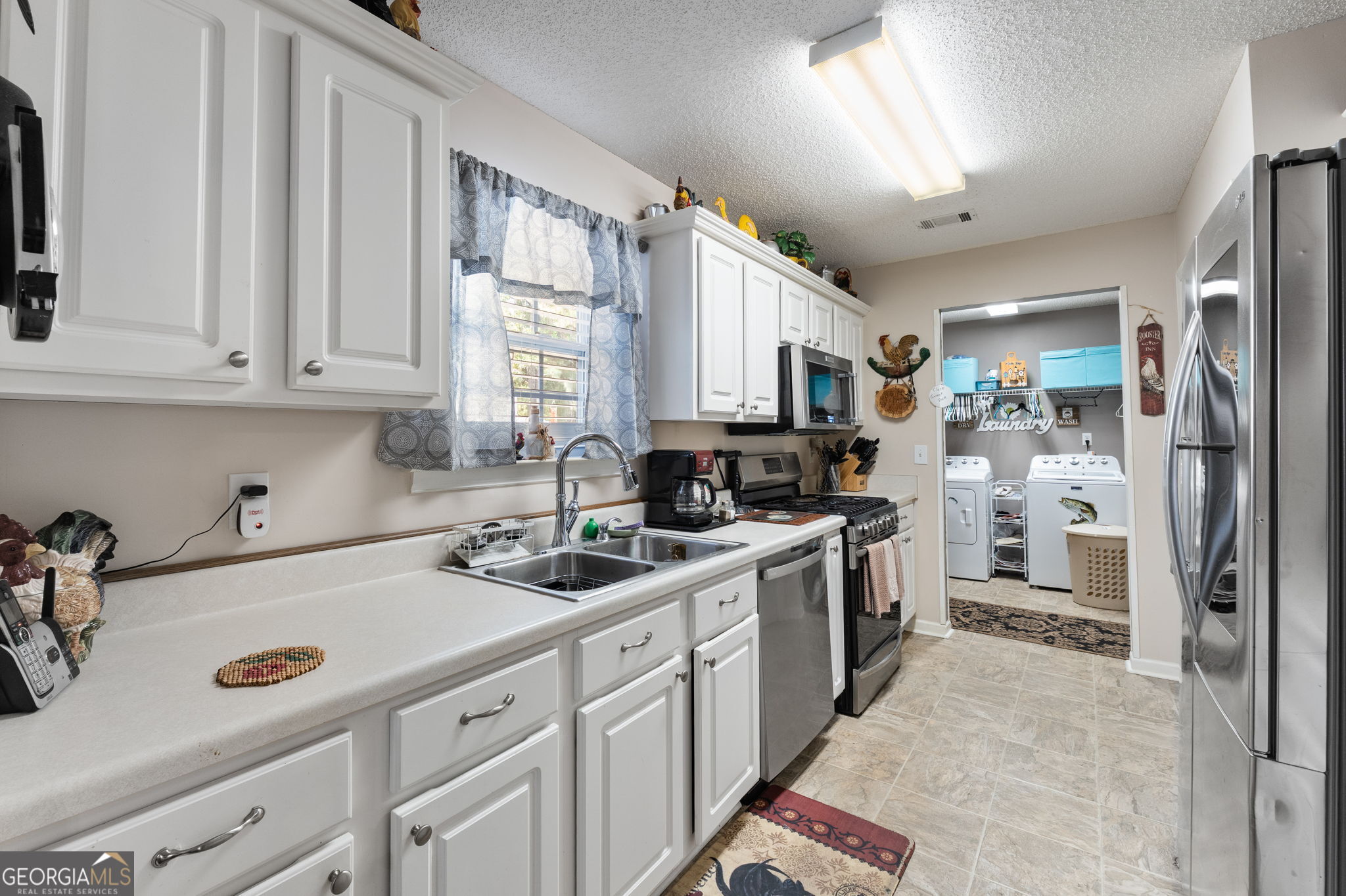 291 Regal Road Jackson, GA 30233 - Photo 8 of 35 a kitchen with a sink stove and cabinets
