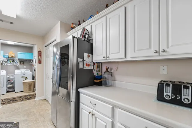 a kitchen with a refrigerator and a sink