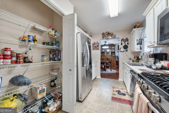 a kitchen with stainless steel appliances granite countertop a refrigerator and stove top oven