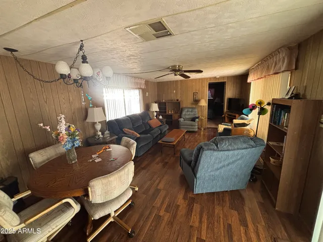 a living room with fireplace furniture and a chandelier