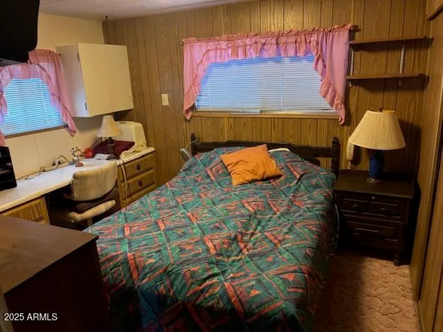 a bedroom with a bed and a lamp